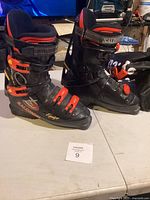 Pair of Salomon Equipe ski boots showing front and side with straps and buckles