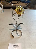 View of Swarovski crystal flower figurine with yellow crystal flower and silver-tone metal stem and base