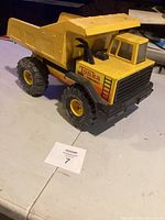 Front angled view of the Tonka Turbo-Diesel dump truck showing yellow dump bed and black cab with decals.