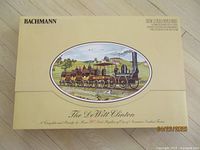Front view of the original yellow box featuring Bachmann branding and image of The DeWitt Clinton train model.