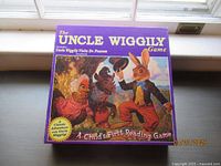 The Uncle Wiggily Game box cover showing colorful anthropomorphic animal characters, titled 'A Child's First Reading Game'.