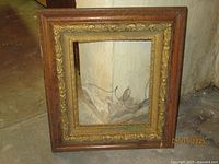 Full view of the vintage oak and gold ornate picture frame, showing its rectangular shape and details.