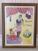 Frontal view of framed perfume advertisement drawing.