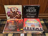 Photo showing a stack of vinyl records including The Complete Artie Shaw Vol. II / 1939, Glenn Miller A Memorial 1944-1969, The Super Concert Vol. 2, and Harum Halisun albums.