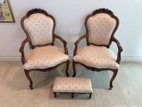Two bergere armchairs front view showing matching upholstery and carved frames