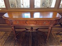 Front view of entire demilune console table showing shape and finish