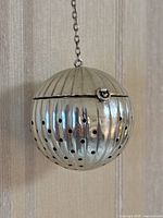 Front view of ribbed, perforated half of spherical infuser ball