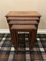 Front view of four nesting tables stacked