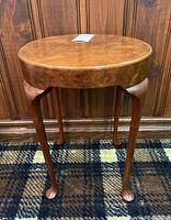 Full view of round burled wood end table showing tabletop and legs