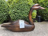 Full side view of the wooden carved Canadian goose decoy showing shape, size, and wood grain.