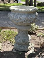 Front angle view of cement planter on pedestal