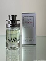 Bottle standing next to its original box, front view