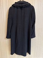 Back view of dark grey wool coat on hanger