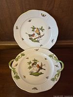 Both pieces displayed together: handled shallow bowl in front and dinner plate behind