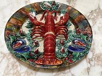 Top-down view of plate showing full lobster sculpture and rim pattern