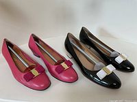 Two pairs of pumps displayed side by side on a white surface