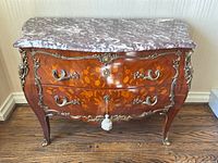 Front view of commode showing rosewood marquetry and marble top