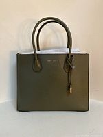 Front view showing Michael Kors logo and padlock charm