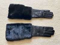 Both gloves laid side by side showing mink fur cuffs and leather sections