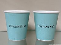 Front view of both mugs side by side, showing the Tiffany & Co. logo