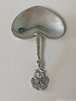 Top view showing the heart-shaped bowl and floral handle detail of the spoon.