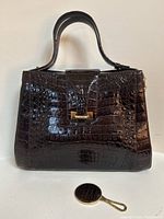 Front view of handbag with mirror for scale