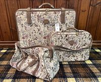 Three-piece set standing together against wood panel background