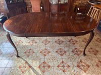 Table fully extended with both leaves inserted showing overall length and oval top