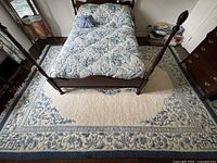 Full view of wool carpet under bed showing overall pattern, color and size