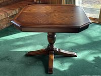 Front view of entire table showing hexagonal top and pedestal base