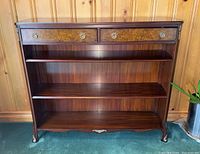 Full front view of the mahogany bookcase showing drawers and shelves