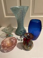 Group of all six glass items on white surface