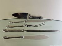 Full view of cake lifter (top) and four-piece carving set laid out