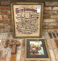 Overview of all three items (needlepoint, painting, crucifix box) on brick background
