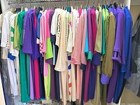 Full rack of assorted size Large women’s dresses in bright colors and prints