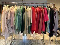 Full rack view showing all hanging blouses and jackets