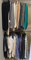 Two-tier closet rack with multiple jackets on top rail