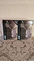 Two boxed Air Innovations Clean Mist Sensa Touch Humidifiers, unopened and in good condition.