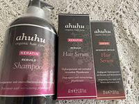 Ahuhu Keratin Rebuild Shampoo in 1L bottle and two boxed hair serums: one Keratin Rebuild Hair Serum 60ml and one Amino Intensive Repair Hair Serum 30ml