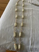 Full view of pearl cluster necklace with gold-tone metal and crystal accents linked by gold chain