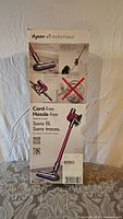 Original packaging box of Dyson V7 Motorhead cordless vacuum showing product details and branding