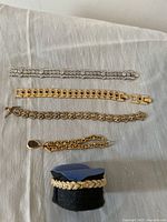 Five bracelets laid out on fabric backdrop