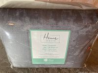 Packaged silver faux mink 6-piece Homesuite sheet set with clear plastic wrapping and product label visible.