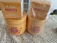 Four jars of M. Asam body products including two boxes of Pure Vitamins 24H Creme and two Sunny Orange cream jars.