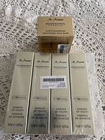 Five M.Asam Resveratrol Premium skin care boxes arranged on a lace cloth surface, showing the front packaging with product names and sizes.