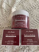 Photo of three M.Asam Retinol Intense skin care products: body cream jar and two boxed creams.