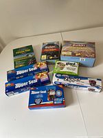 Photo showing multiple boxes of zipper seal bags and garbage bags on white table.