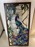 Full frontal view of the rectangular framed resin artwork illustrating a peacock with a garden background, dimensions approximately 41x20 inches.