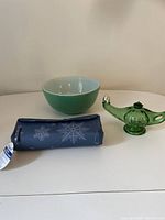 Photo showing the trio: green Pyrex bowl, green glass genie lamp, and blue snowflake insulated lunch bag.