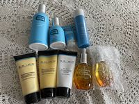 Full view of all Skinn and Skinfix products including tubes and bottles on a lace tablecloth.